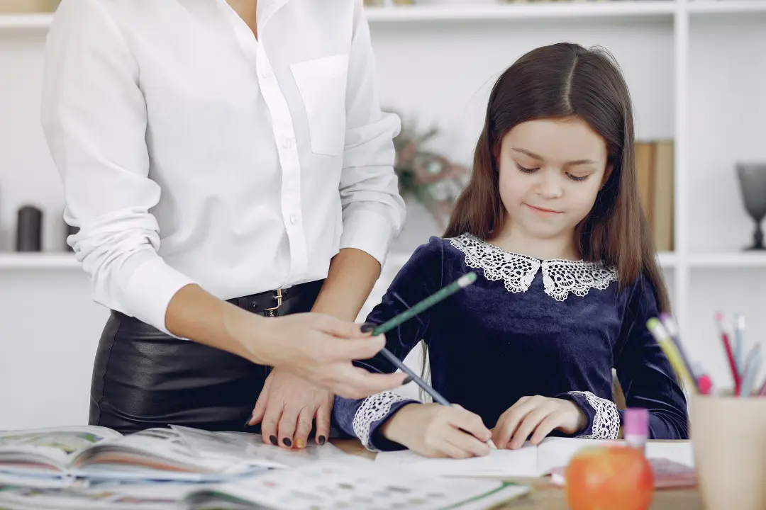 Adult and child collaborating on creative work at a table